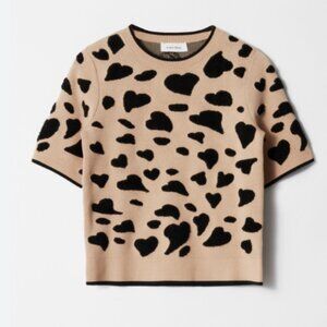 Short-sleeve knitted jacquard top featuring a ribbed neckline, cuffs and hem.  •